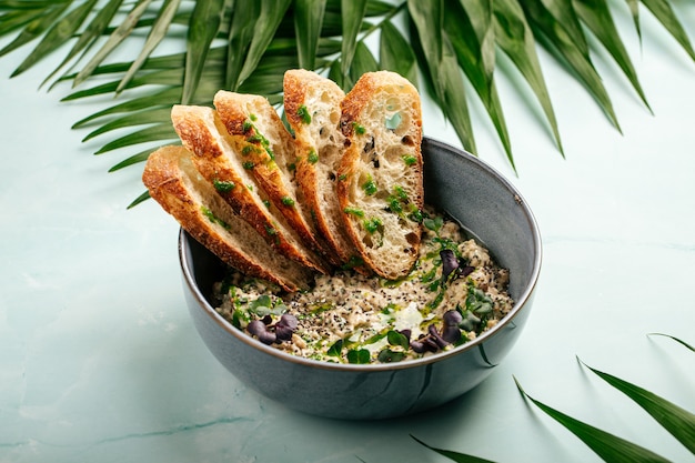 Bowl of savory hummus with toasted bread