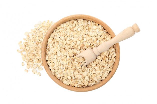 Bowl and scoop with oatmeal flakes isolated on white