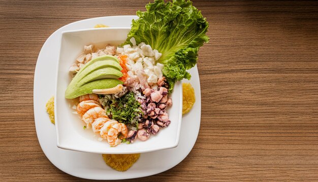 A bowl of seafood with shrimps and avocado