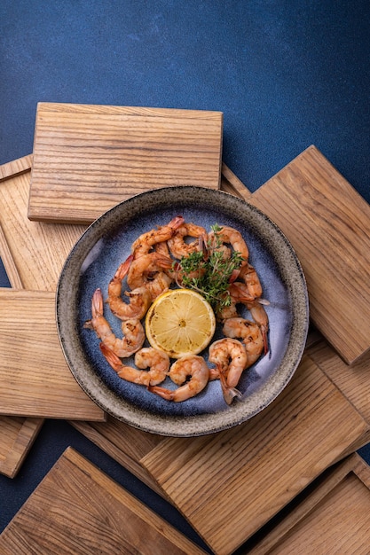 A bowl of shrimp with lemon on top