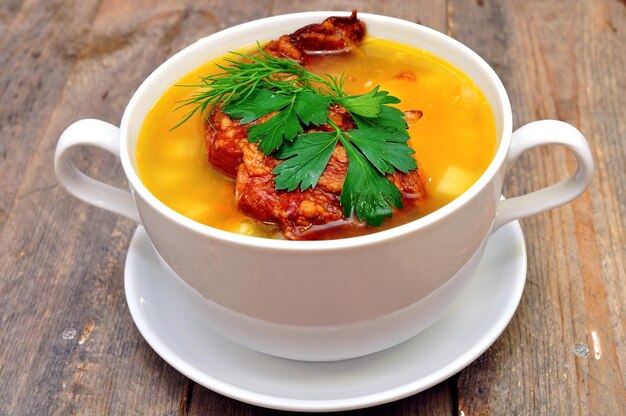 A bowl of soup with a spoon on a plate