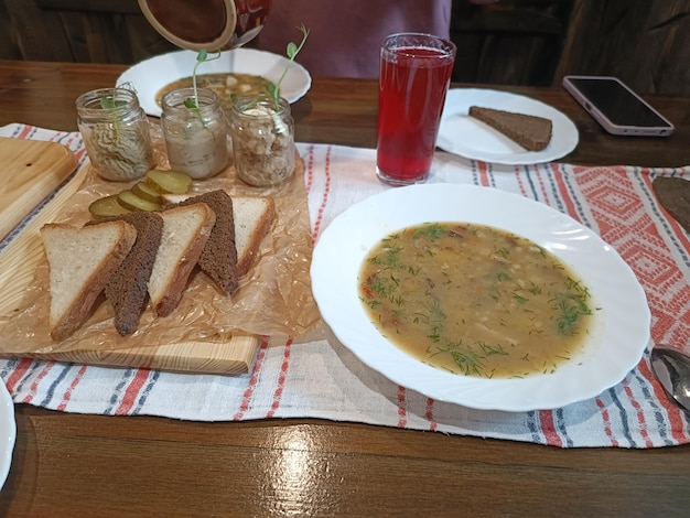 A bowl of soup with a spoon on the side