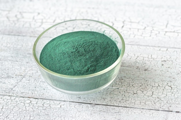 Bowl of spirulina on the wooden table