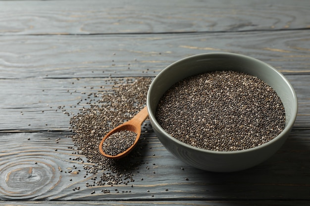 Bowl and spoon with chia on wooden