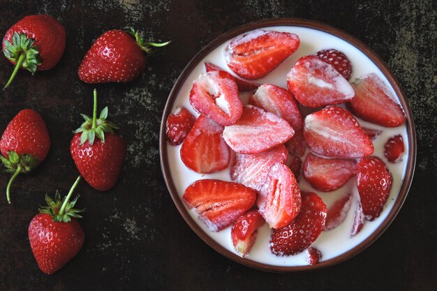 A bowl of strawberries with cream. Colorful healthy dessert. Keto diet. Keto dessert.