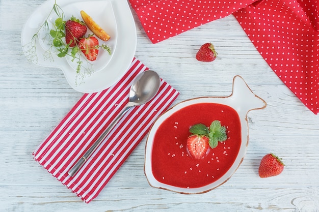 A bowl of strawberry soup gazpacho with mint