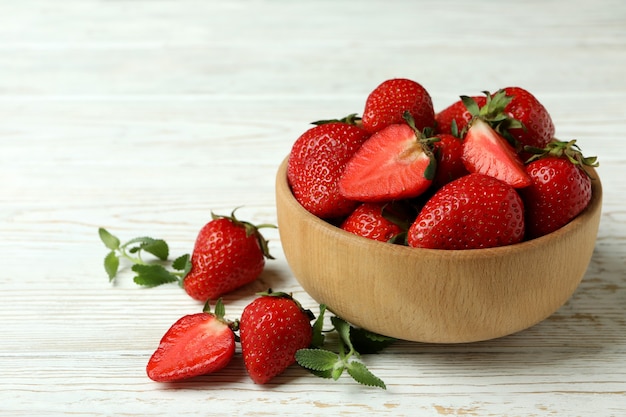 Bowl of strawberry on white wooden