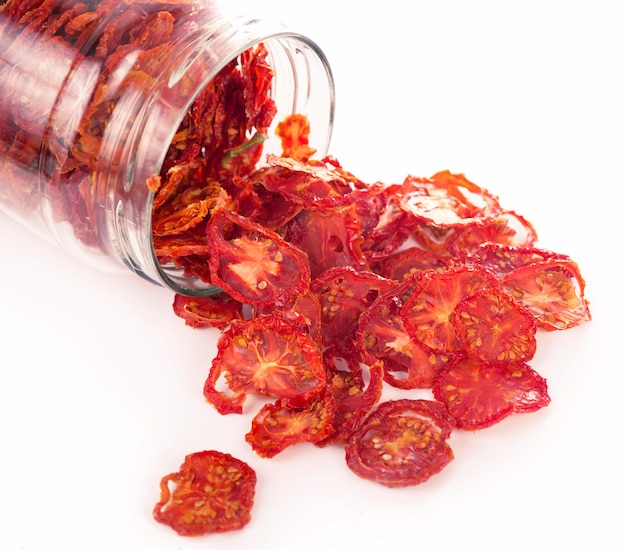 Bowl of sun dried tomatoes on wooden surface, top view