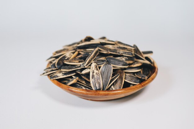 Bowl of Sunflower seeds isolated on white background