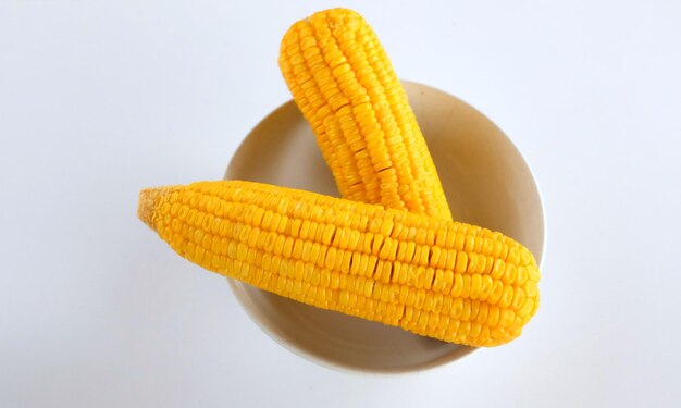 Bowl of sweet ripe corn isolated on white background