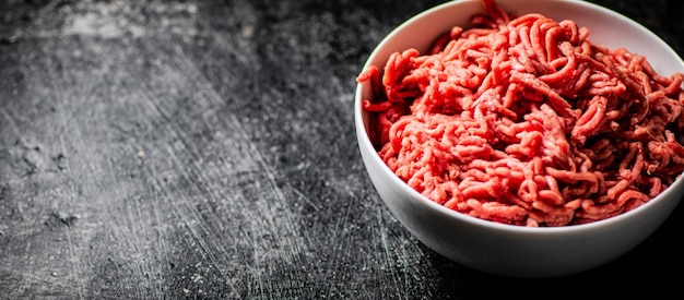 Bowl on the table with fresh minced meat