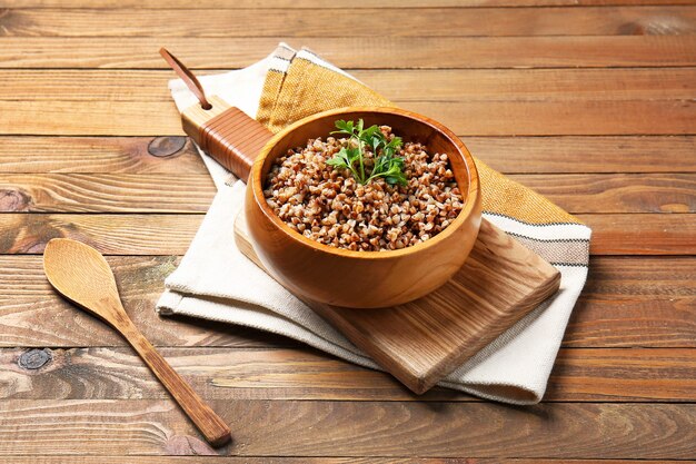 Bowl of tasty buckwheat porridge on table