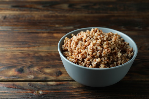 Bowl of tasty buckwheat on wooden table