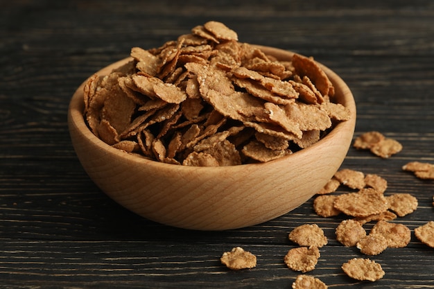 Bowl of tasty muesli on wooden table