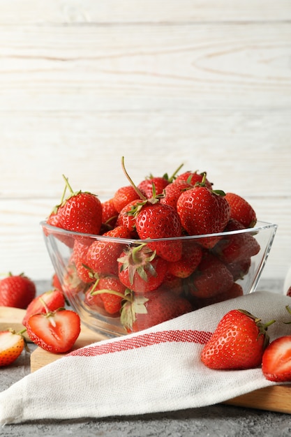 bowl of tasty strawberry on gray table