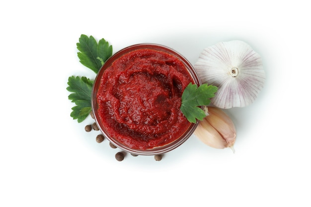 Bowl of tomato paste isolated on white background