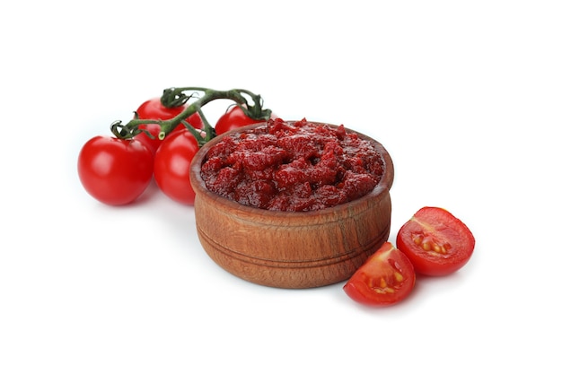 Bowl of tomato paste and tomatoes isolated on white background