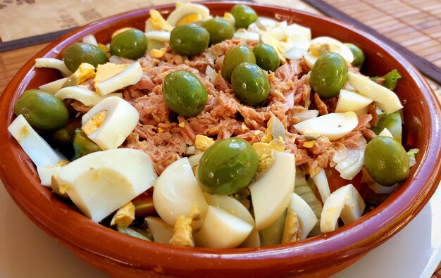 A bowl of tuna salad with green onions and sliced green onions