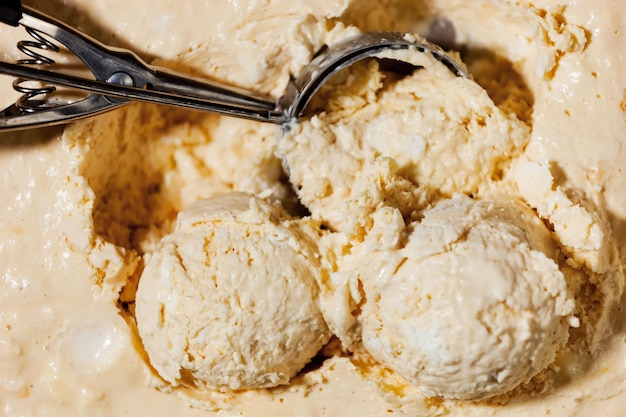 A bowl of vanilla ice cream with two spoons and two spoons