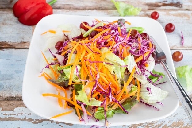 Bowl of vegetable salad on wooden table