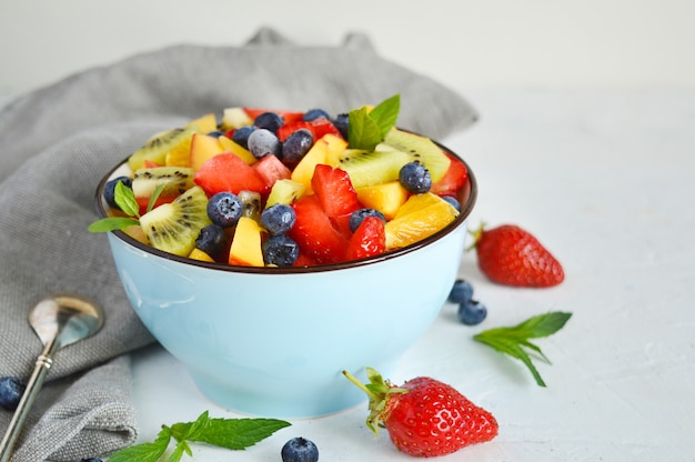 Bowl of vegetarian fresh fruit salad of different fruits