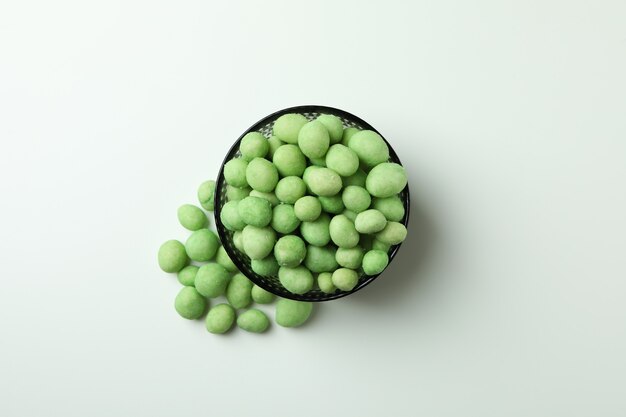 Bowl of wasabi nuts on white