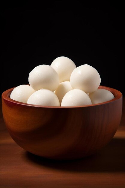 a bowl of white eggs with a black background.