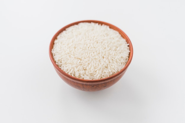 Bowl of white rice grain on white background