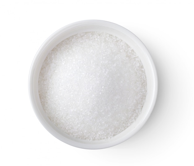 Bowl of white sugar on white table