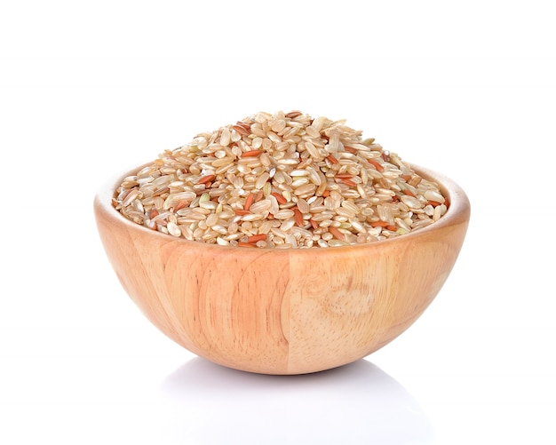 Bowl of whole brown rice isolated on white