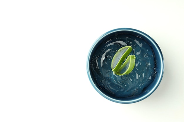 Bowl with aloe gel and slices on white background