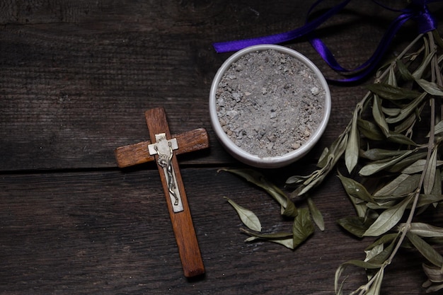Photo bowl with ashes, olive branch and cross, symbols of ash wednesday