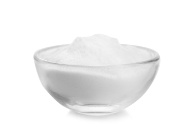 Bowl with baking soda on white background