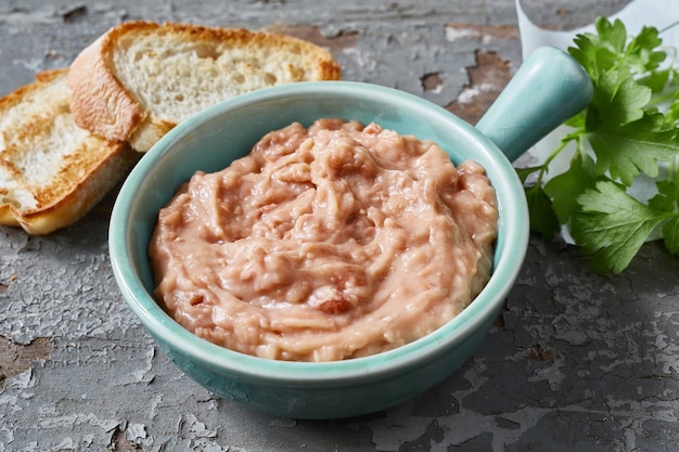 Bowl with bean pate on table