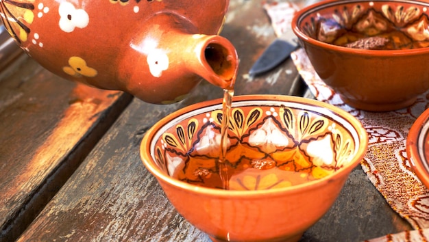 Bowl with black tea on the table