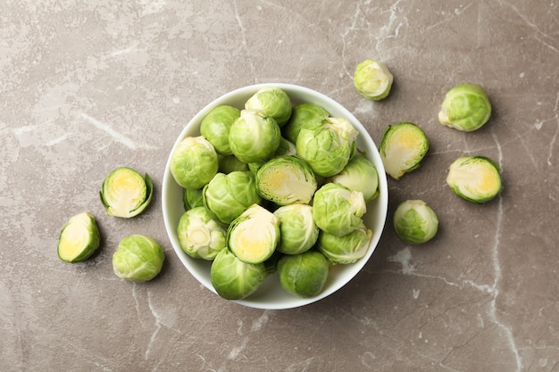 Bowl with brussels sprout on grey surface