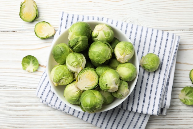 Bowl with brussels sprout on wooden surface