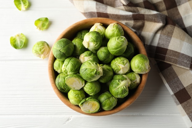 Bowl with brussels sprout on wooden surface