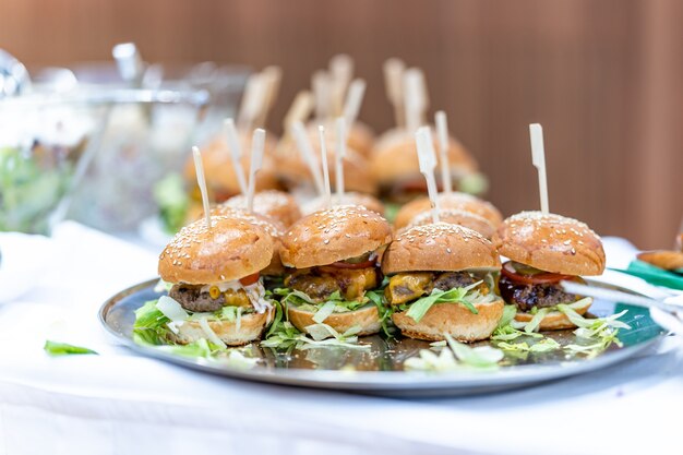 Bowl with burgers on a catering table