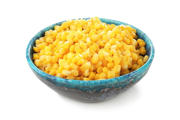 Bowl with canned corn kernels on white background