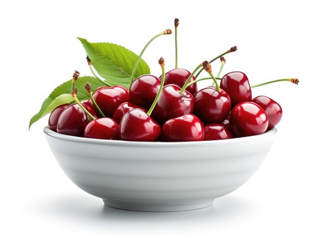 Bowl with cherries and green leaves on a white background