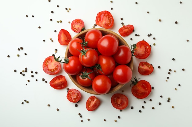 Bowl with cherry tomato on white background