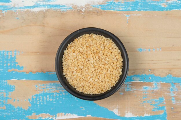 Bowl with chickpea on blue rustic wooden table