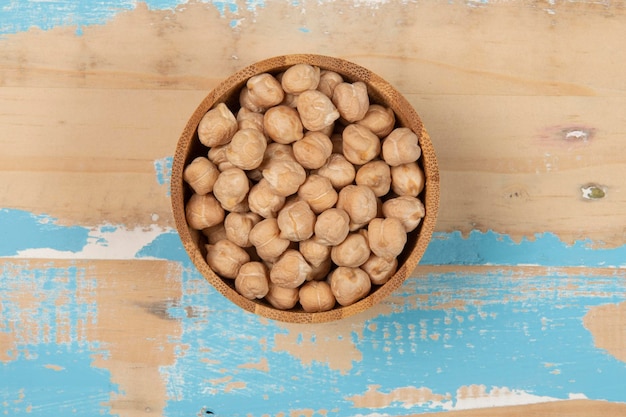 Bowl with chickpea on blue rustic wooden table