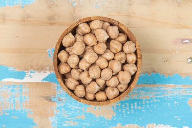 Bowl with chickpea on blue rustic wooden table