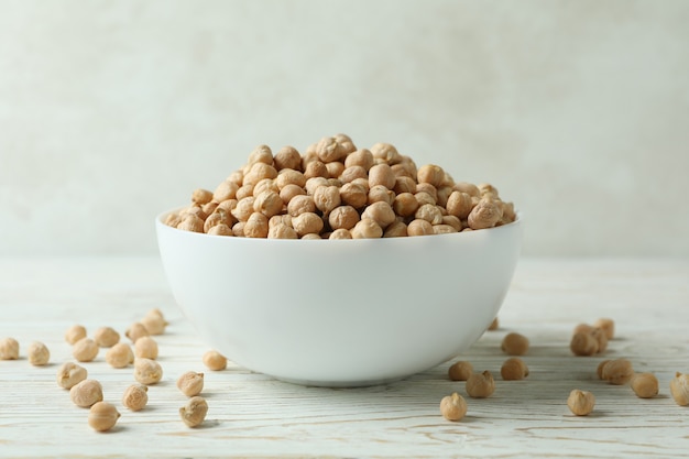 Bowl with chickpea on white wooden table