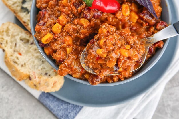 Bowl with chili con carne on table