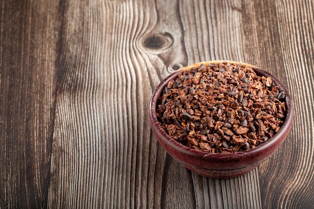 Bowl with cocoa nibs on the table