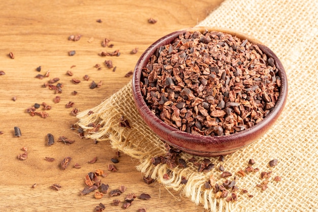 Bowl with cocoa nibs on the table