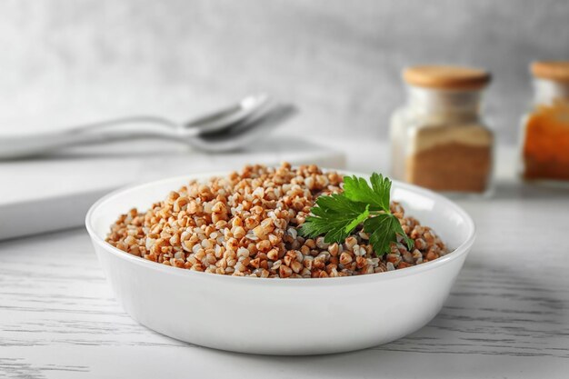 Photo bowl with cooked buckwheat on table